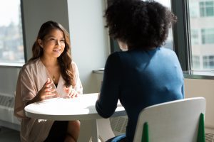 woman interviewing for position because she asked for an interview in a cover letter